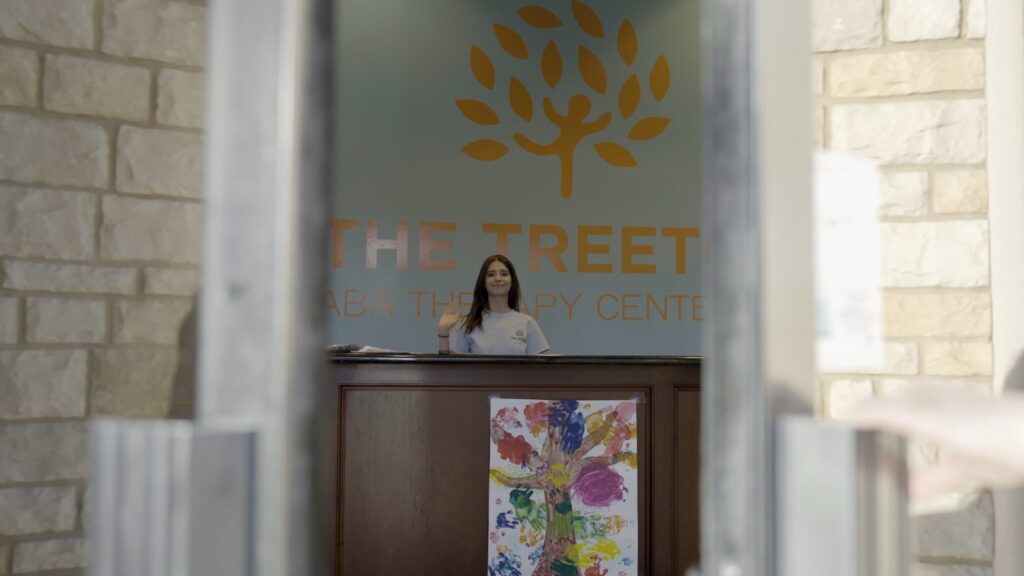 Treetop ABA Mesa center receptionist waving at the front desk