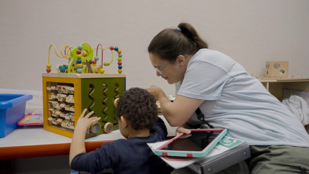 Treetop ABA therapist guiding a child through a learning activity