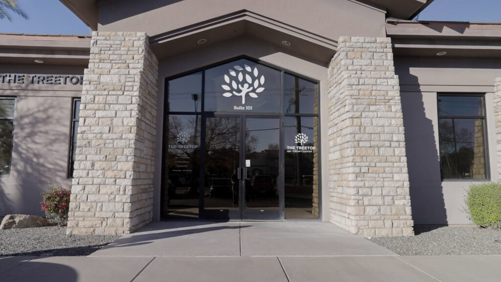 Treetop ABA therapy center entrance with logo on glass door