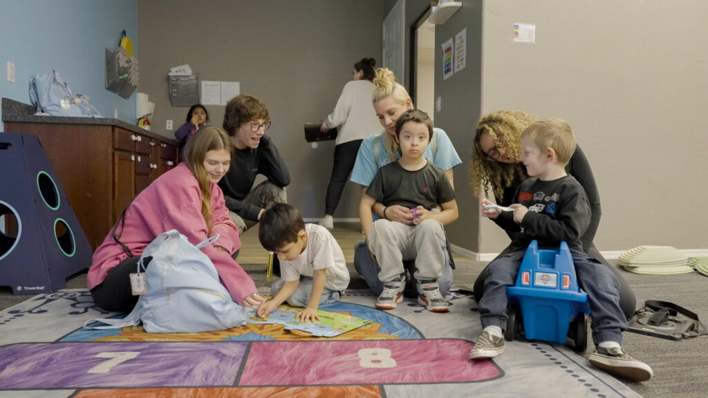Multiple children and Treetop therapists during group play session