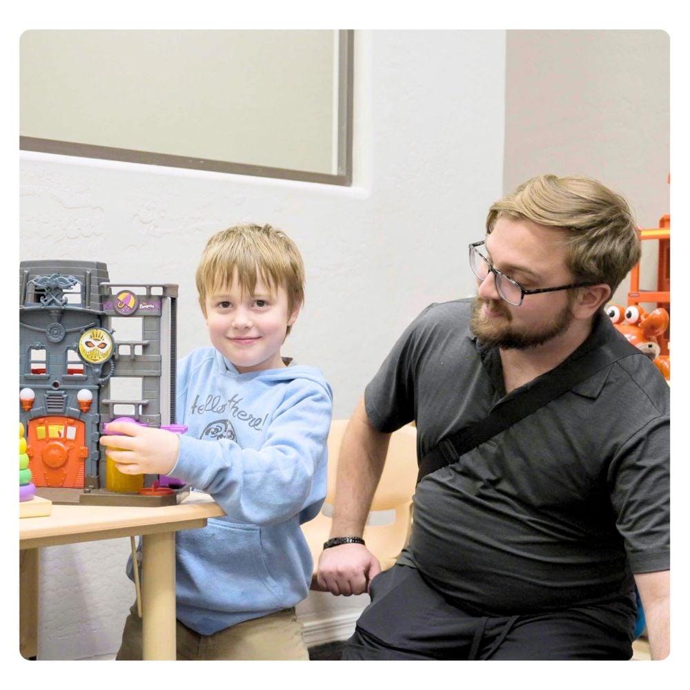 Treetop therapist during play-based ABA session with child