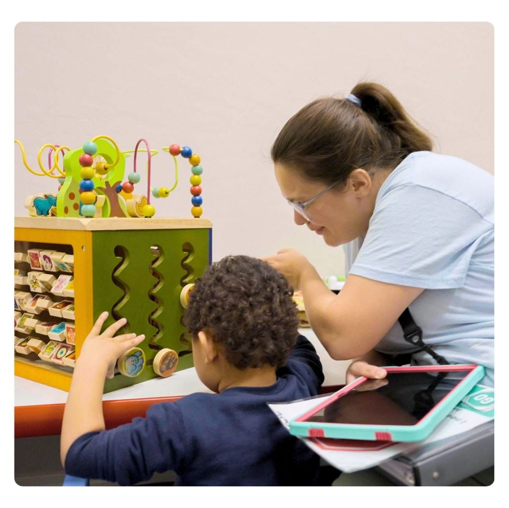 Treetop therapist working with child using learning tools