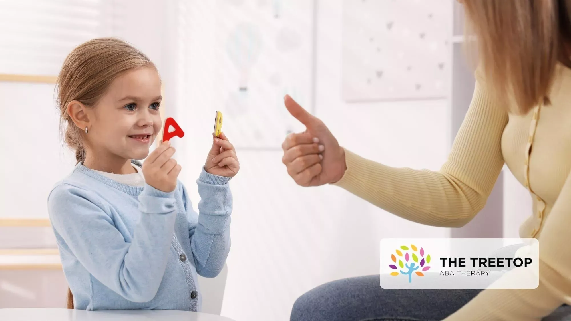 Woman showing a thumb drive to a smiling child in a bright room.
