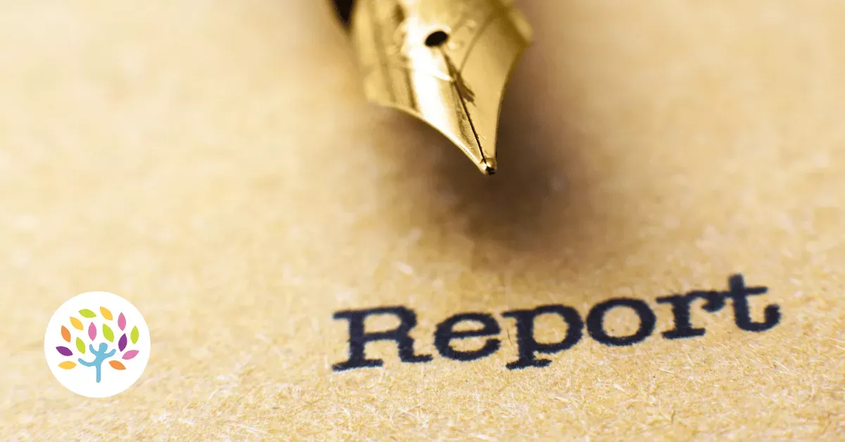 A gold fountain pen rests on a piece of textured paper with the word "Report" printed in black.